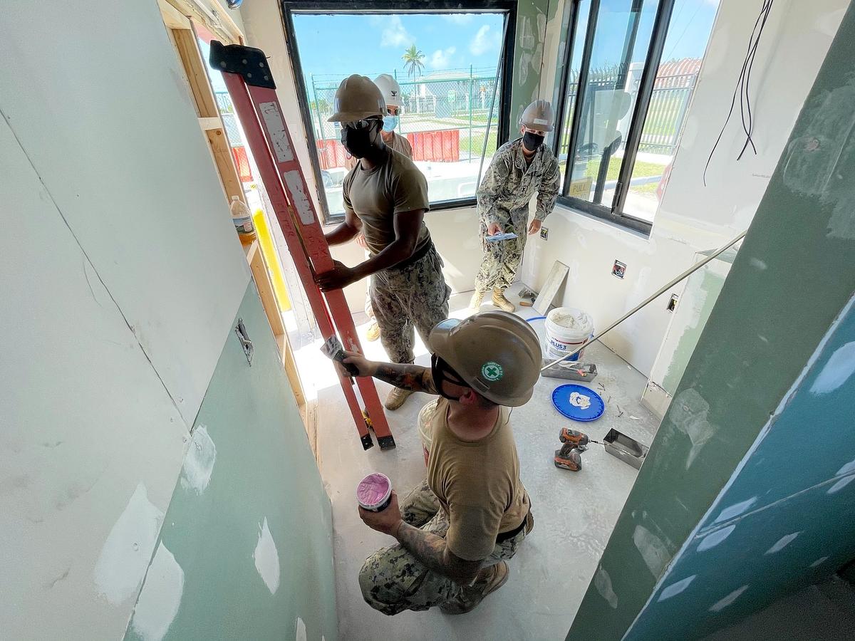 Utilitiesman 2nd Class Matthew Konopka, Builder 1st Class Courtney Mejia and Builder 2nd Class Anthony Seaton repair drywall during a remodel of the Truman Annex entry control point facility. (Trice Denny/Navy) Navy creates one Seabee rating for E-9s as service aims to facilitate promotion opportunities