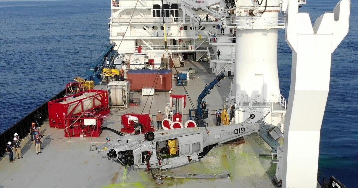A U.S. Navy MH-60S helicopter lies upside down on the deck of a contracted salvage vessel off the coast of Okinawa, Japan, March 18. The helo, which crashed into the Philippine Sea Jan. 25, 2020, was pulled from a depth of Navy recovers MH-60S helicopter, nearly 20,000 feet underwater, in new record