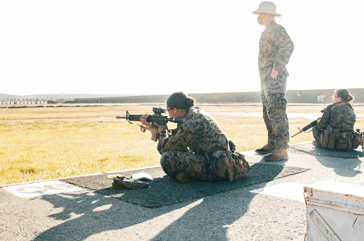 Marine Corps Recruit Jazzmin Stewart with Lima Company, 3rd Recruit Training Battalion, shoots in the sitting position during a slow-fire drill as part of the prequalifications at Edson Range aboard Marine Corps Base Camp  For the first time, women become Marines at San Diego recruit depot