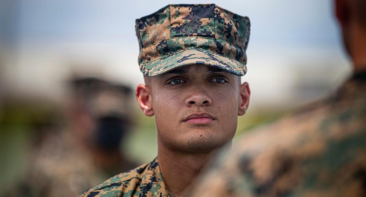 Cpl. Dominick Bonner, a chemical, biological, radiological and nuclear defense specialist with the 1st Marine Aircraft Wing, stands at attention to receive a Navy and Marine Corps Commendation Medal on Marine Corps Air Sta Okinawa Marine recognized for saving restaurant workerâ€™s life