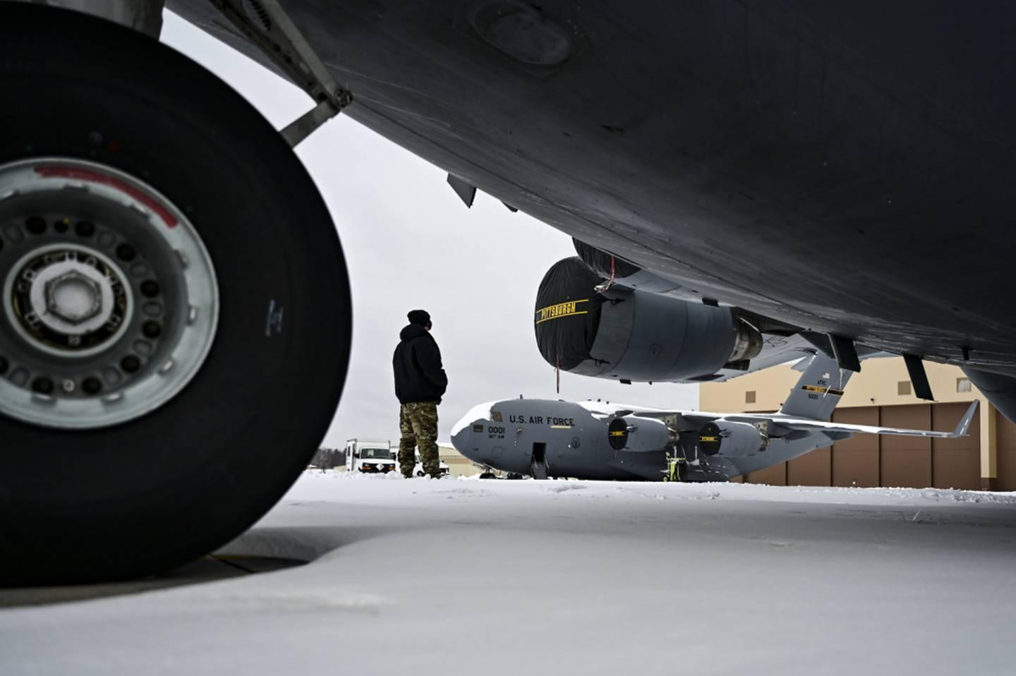 An Airman assigned to the 911th Aircraft Maintenance Squadron conducts a walk-around inspection on a C-17 Globemaster III at the Pittsburgh International Airport Air Reserve Station, Pennsylvania, on Feb. 1, 2021. (Joshua  Hair, hands and hosiery: Air Force overhauling outdated rules on airmenâ€™s looks