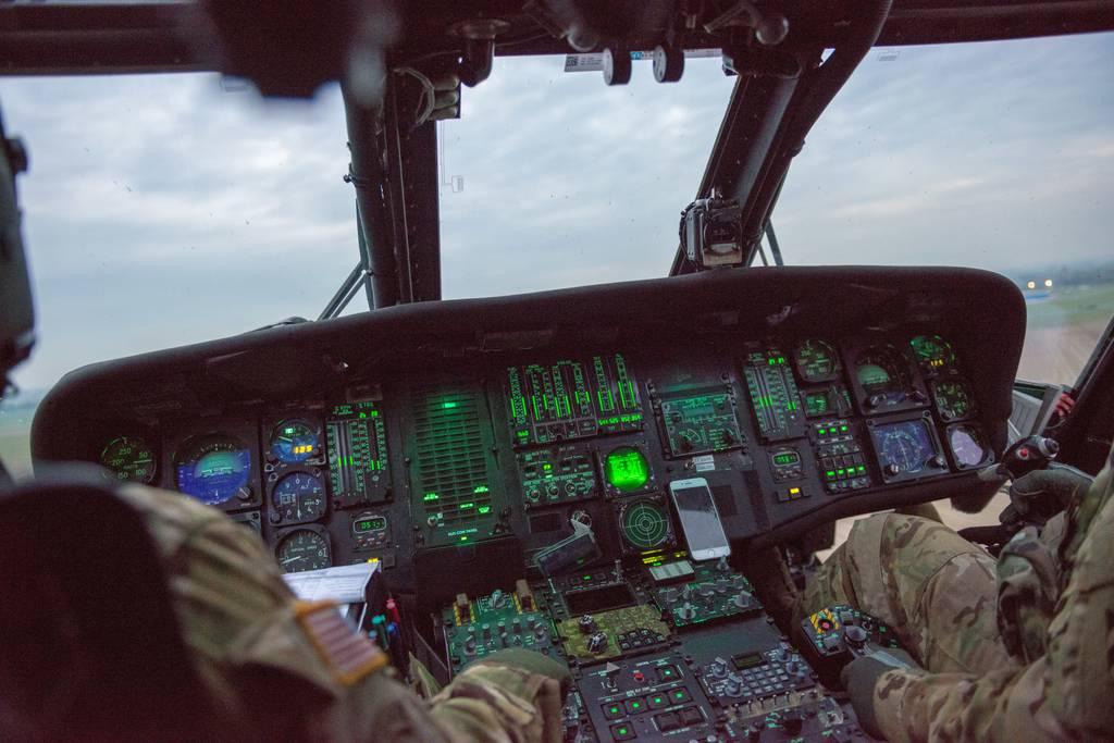 The cockpit of a U.S. Army UH-60-L Black Hawk helicopter of the 3rd Combat Aviation Brigade, 3rd Infantry Division, is lit, over ChiÃ¨vres Air Base, Belgium, Oct. 23, 2019. (Pierre-Etienne Courtejoie/Army) Army Black Hawk pilot builds tool to improve flight training, wins competition