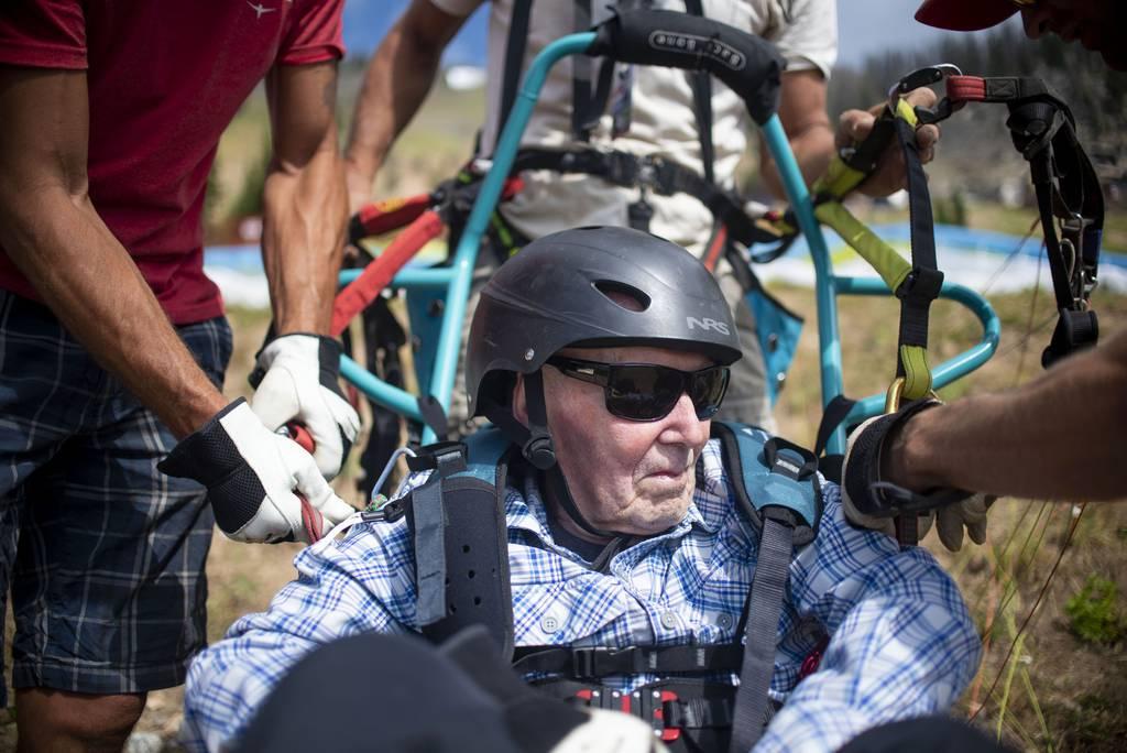 Fred Miles is strapped into an adaptive paragliding chair before his adaptive paragliding flight at Jackson Hole Mountain Resort on Wednesday, July 28, 2021 in Teton Village, Wyo.. At 103 years old, Miles set a record for  Veteran takes flight, sets adaptive paragliding record at 103