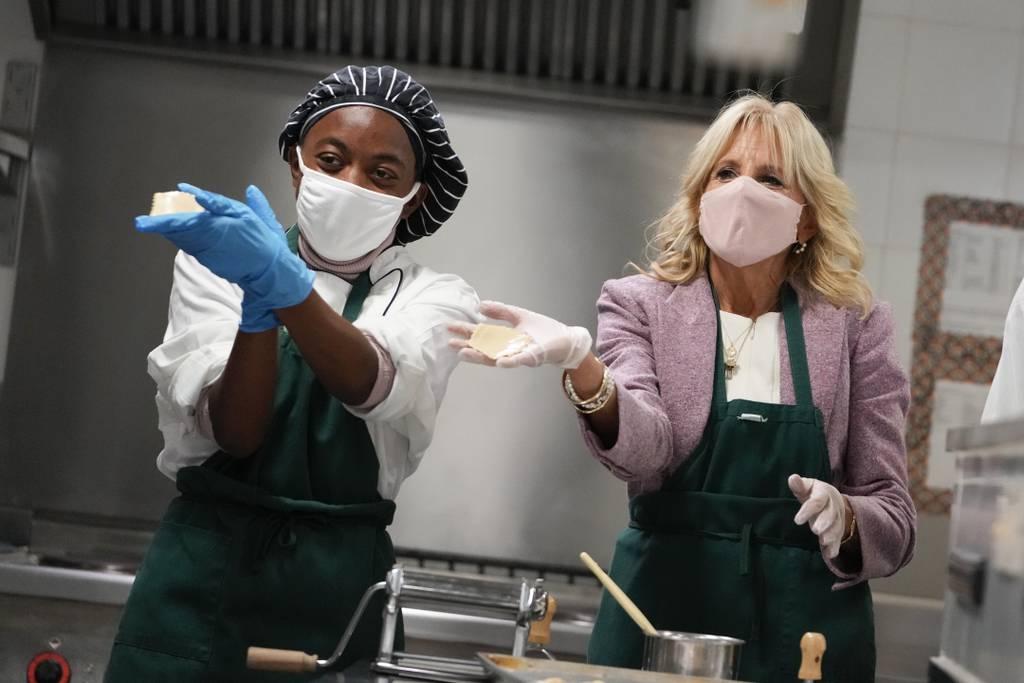 U.S. first lady Jill Biden, right, shows the dough as she helps making ravioli in culinary class during a visit to Naples Middle High School, a Department of Defense Education Activity (DoDEA) school, after attending event First lady helps students at DoD school in Italy make pasta