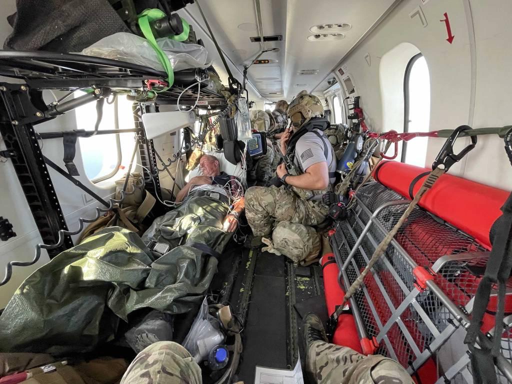 U.S. Air Force PJs treat U.K. mariner Kevin Nixon on board a DHC-8 airplane during a complex two-day medical evacuation from the Indian Ocean, Nov. 13-14, 2021. (AFRICOM) PJs rappel from Osprey to rescue UK mariner off Kenyaâ€™s coast