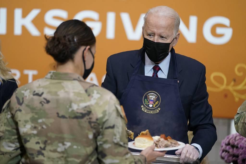 President Joe Biden serves dinner during a visit to soldiers at Fort Bragg to mark the upcoming Thanksgiving holiday, Monday, Nov. 22, 2021, in Fort Bragg, N.C. (Evan Vucci/AP) Bidens serve Thanksgiving meal to service members, families at Fort Bragg