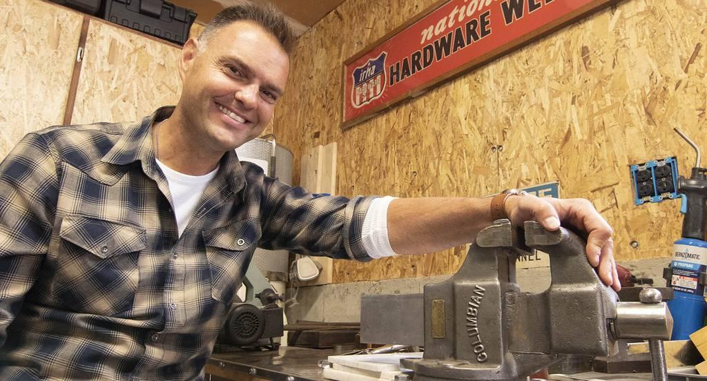 Justin Billard of Brighton Township, Michigan, exhibits one of his more prized restorations, a Columbian bench vise perhaps dating back to pre-1949. Tuesday, Nov. 9, 2021. (Gillis Benedict/Livingston County Daily Press & A Iraq War veteran launches business to employ former service members