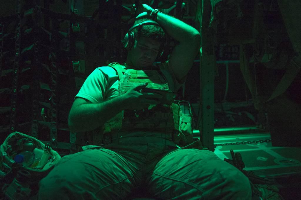 A soldier with the Task Force Hurricane 1-124 Infantry Regiment watches a movie on a personal electronic device on board a C-130J Hercules at an undisclosed location in Africa, Dec. 23, 2016. (Tech. Sgt. Joshua J. Garcia/A Army â€˜significantlyâ€™ expanding bring-your-own-device pilot