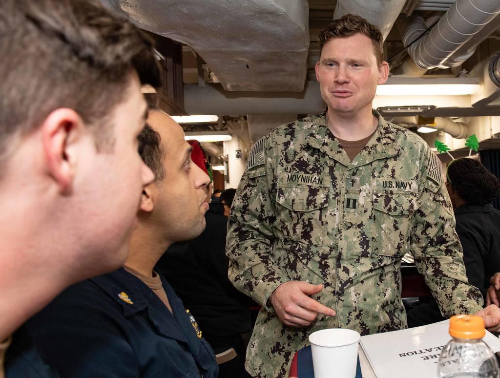Lt. Matthew Moynihan, a chaplain aboard the Japan-based guided-missile destroyer Higgins, greets sailors during an event last month. The Navy has begun making chaplains a permanent part of the destroyer fleet's crew. (MC3  The Navy is making chaplains a permanent part of destroyer crews