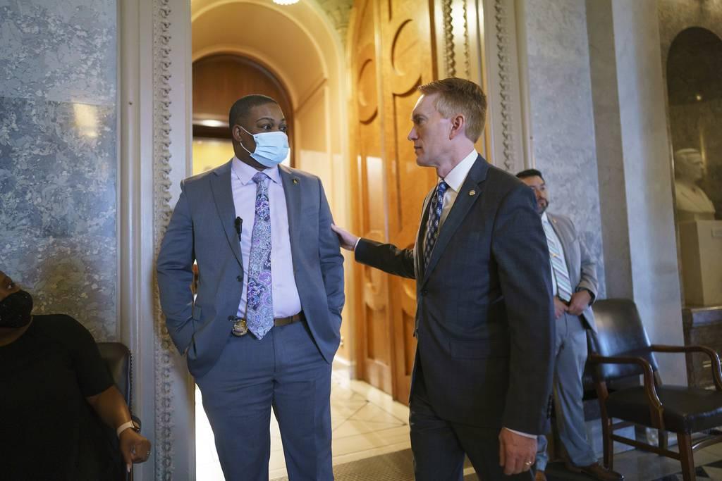 Sen. James Lankford, R-Okla., (right) greets U.S. Capitol Police officer Eugene Goodman (left), who diverted the rioters from the Senate chamber during the Jan. 6 storming of the Capitol, following the vote on May 28, 2021 Hero Capitol Police officer credits military training for his calm on Jan. 6