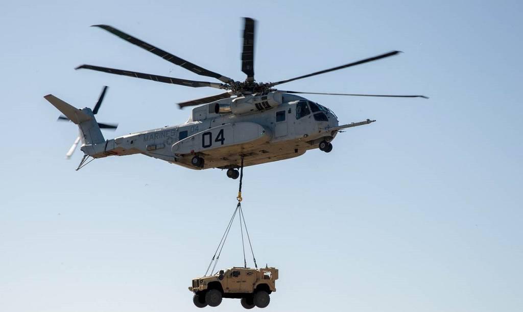 A CH-53K King Stallion lifts a joint light tactical vehicle during a demonstration. (Navy) Marine Corpsâ€™ new CH-53K finally makes it to the fleet