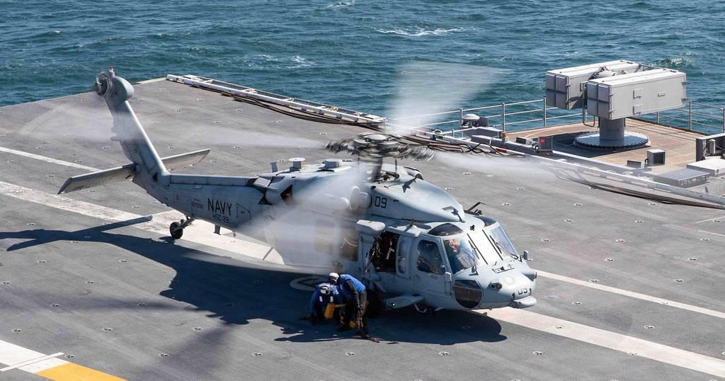 An MH-60S Sea Hawk helicopter attached to Helicopter Sea Combat Squadron 22 prepares to take off from the flight deck of the aircraft carrier Gerald R. Ford Feb. 28, 2022. Ford was underway in the Atlantic Ocean after comp USS Ford completes maintenance availability, sea trials ahead of 2022 deployment