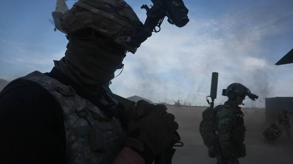 A soldier with 1st Armored Division, left, and a Green Beret with 1st Special Forces Group prepare to load into a CH-47D Chinook helicopter during a training exercise at White Sands Missile Range, New Mexico, April 1, 2021 Army special operations gets new training center in New Mexico