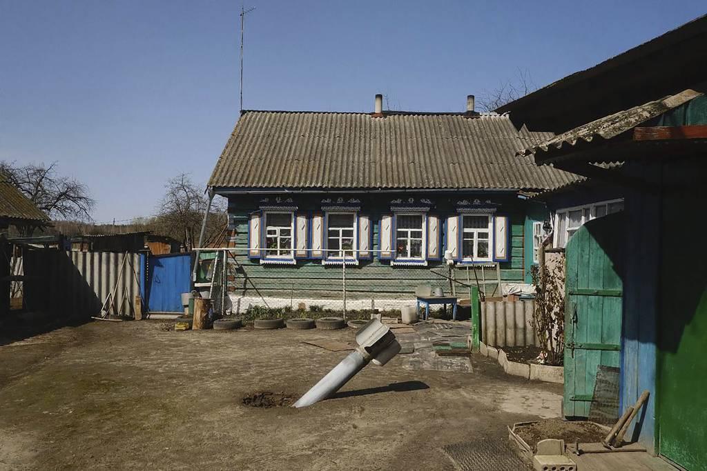 The tail of a missile in a yard of a residential area in a village of Senkivka, near the Belarus border, Chernihiv region, Ukraine, Thursday, April 14, 2022. (AP Photo/George Ivanchenko) Russia says missile attacks on Kyiv will increase