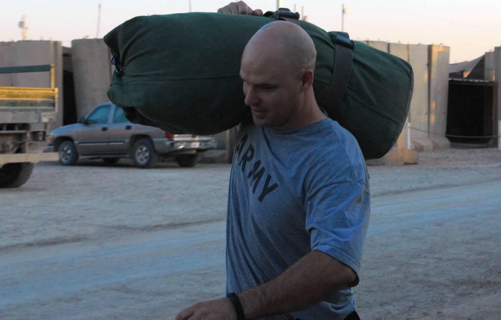 Belton, Texas native, Maj. Christopher Allen, carries a weighted duffel bag during an alternative physical training session. (Army) 23 things veterans may carry for life