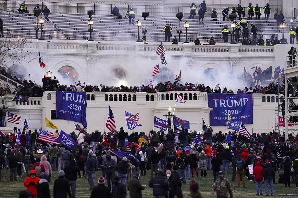 In this Jan. 6, 2021, file photo, violent protesters loyal to President Donald Trump storm the Capitol in Washington. (John Minchillo/AP) Army veteran sentenced to 7 years in prison on Capitol riot charges